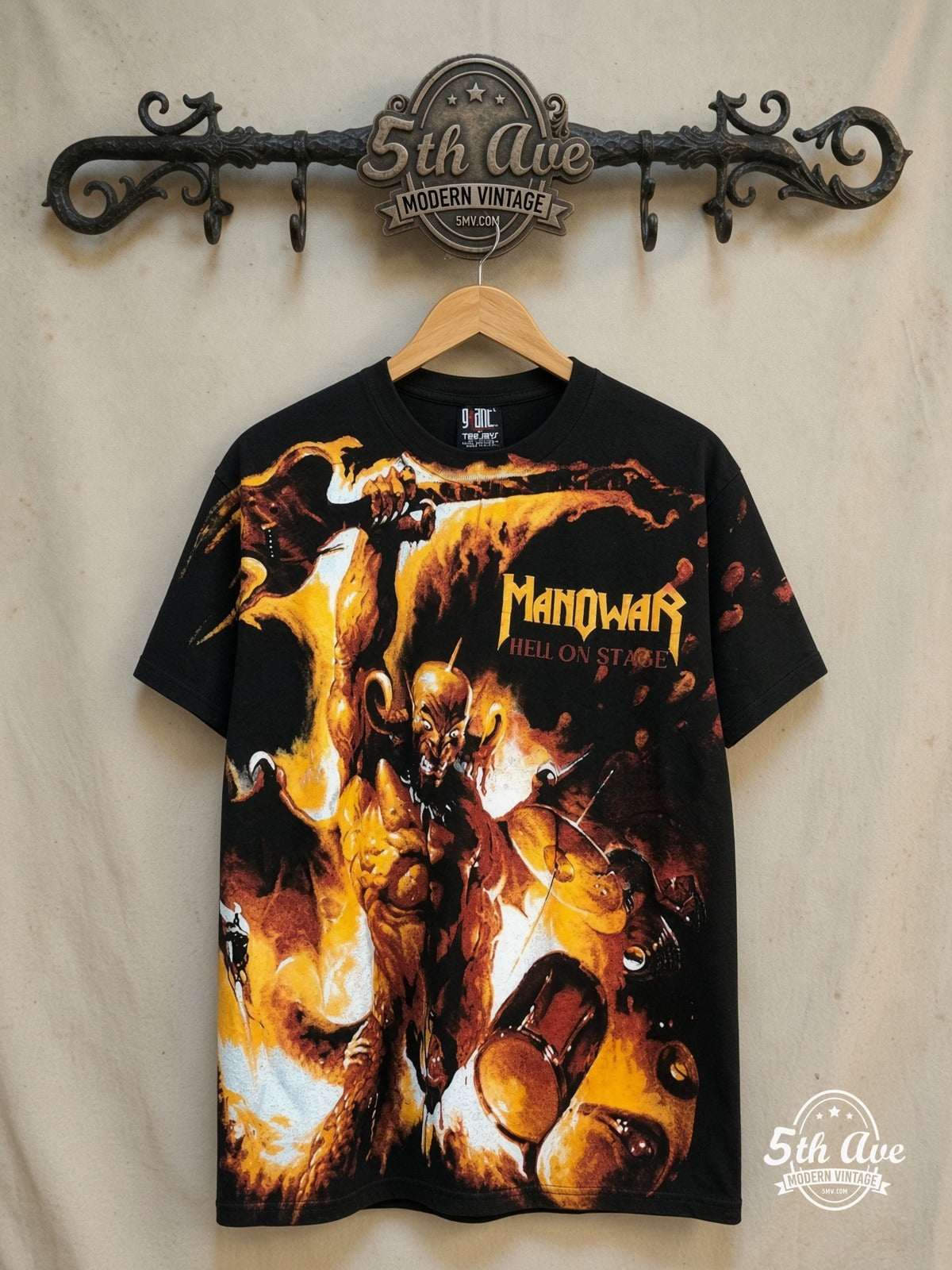Manowar – Hell on Stage All Over Print T-Shirt – Vintage Band T-Shirt — front on locked cream ornate 5th Ave rack