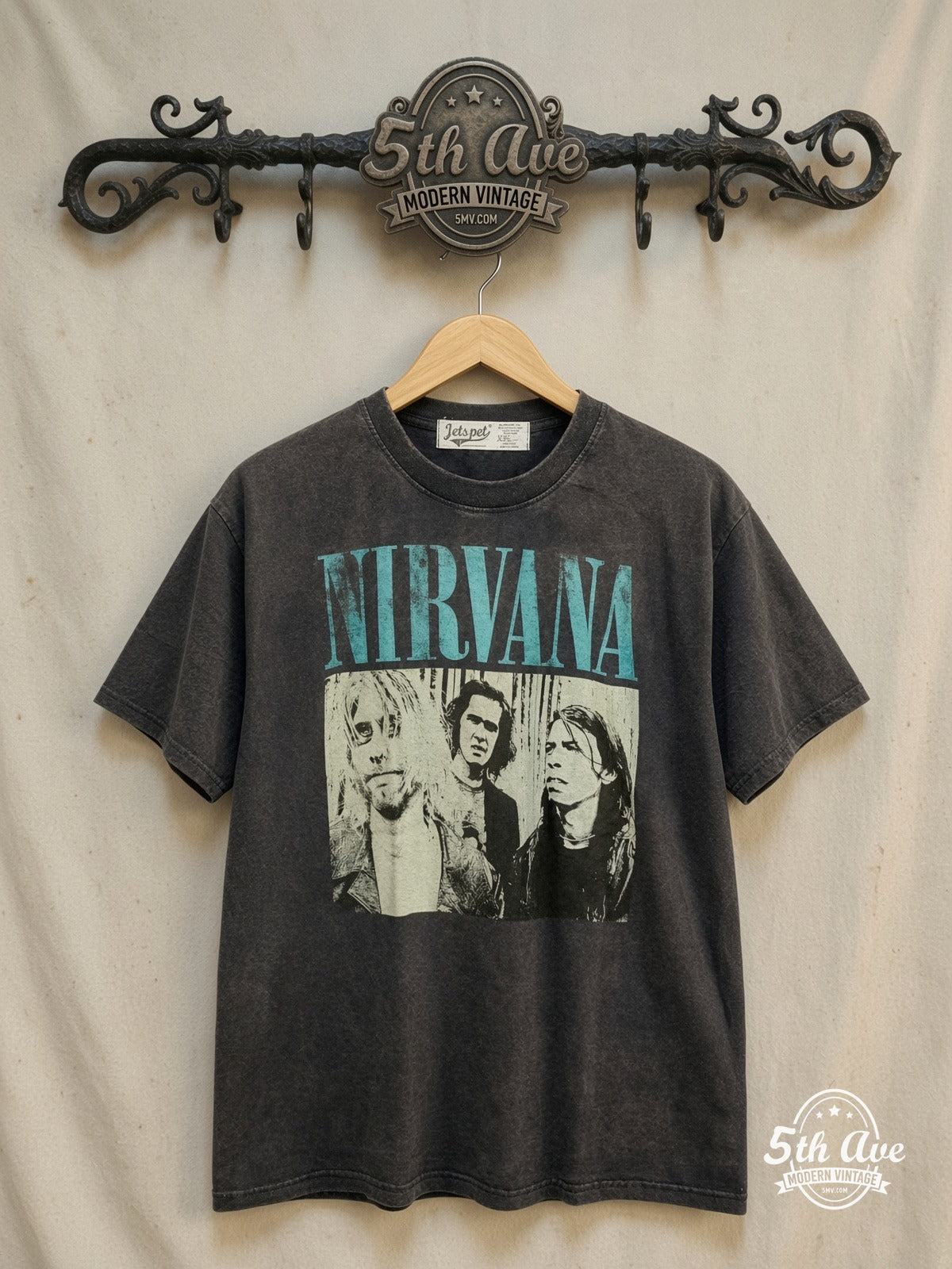 Nirvana – Teal Logo Band Trio Photo – Vintage Band T-Shirt — front on locked cream ornate 5th Ave rack