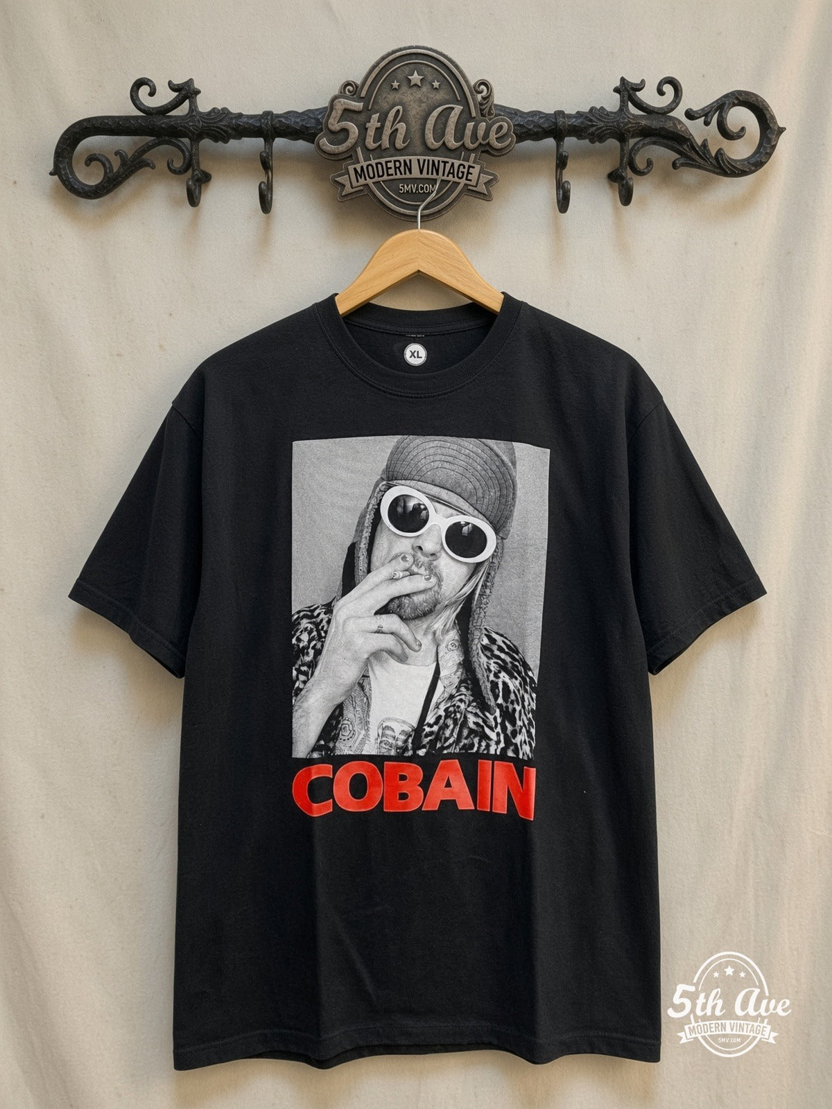 Nirvana – Classic Retro Graphic – Vintage Band T-Shirt — front on locked cream ornate 5th Ave rack