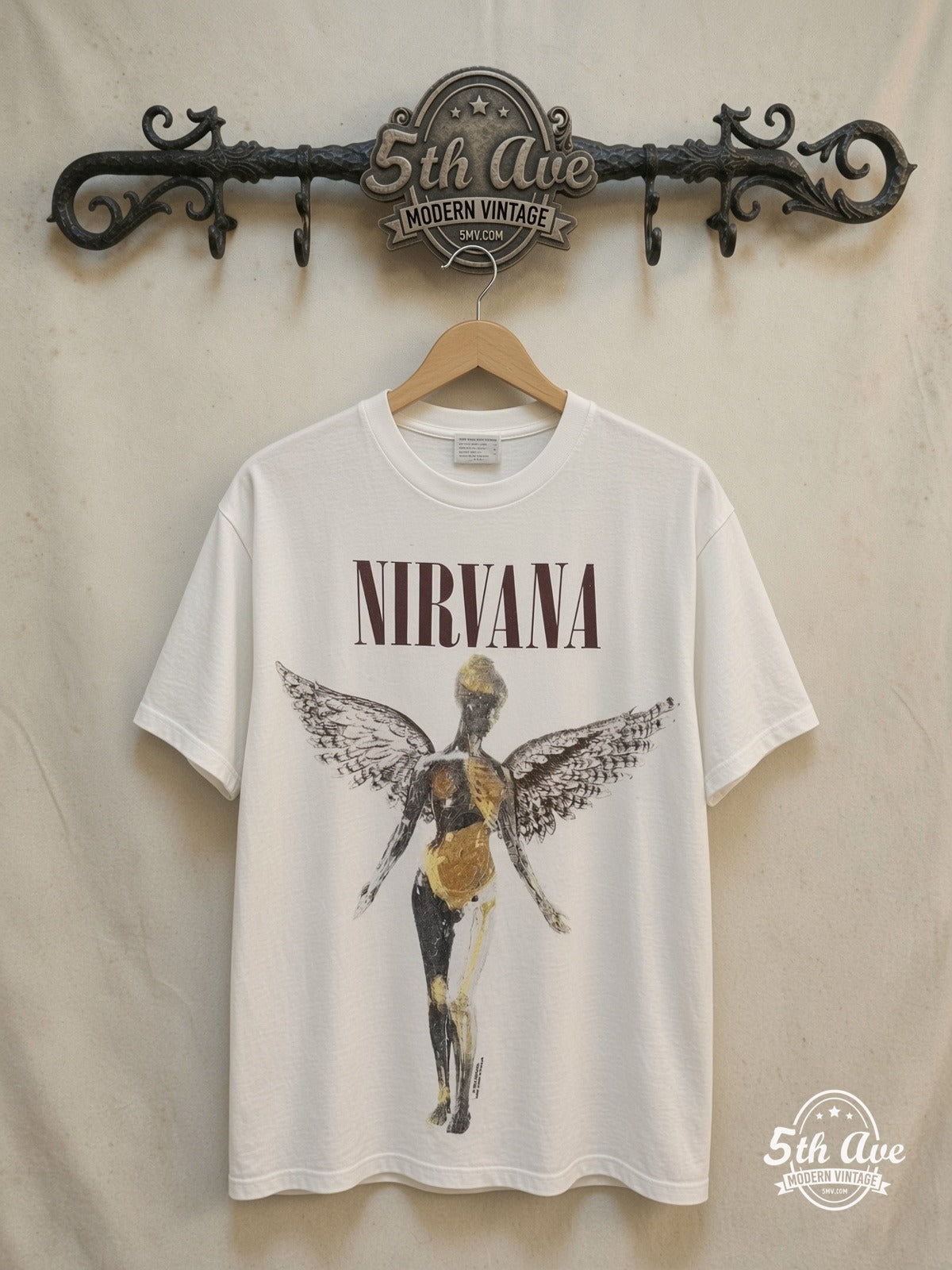 Nirvana – In Utero Classic Angel Dark Logo White – Vintage Band T-Shirt — front on locked cream ornate 5th Ave rack