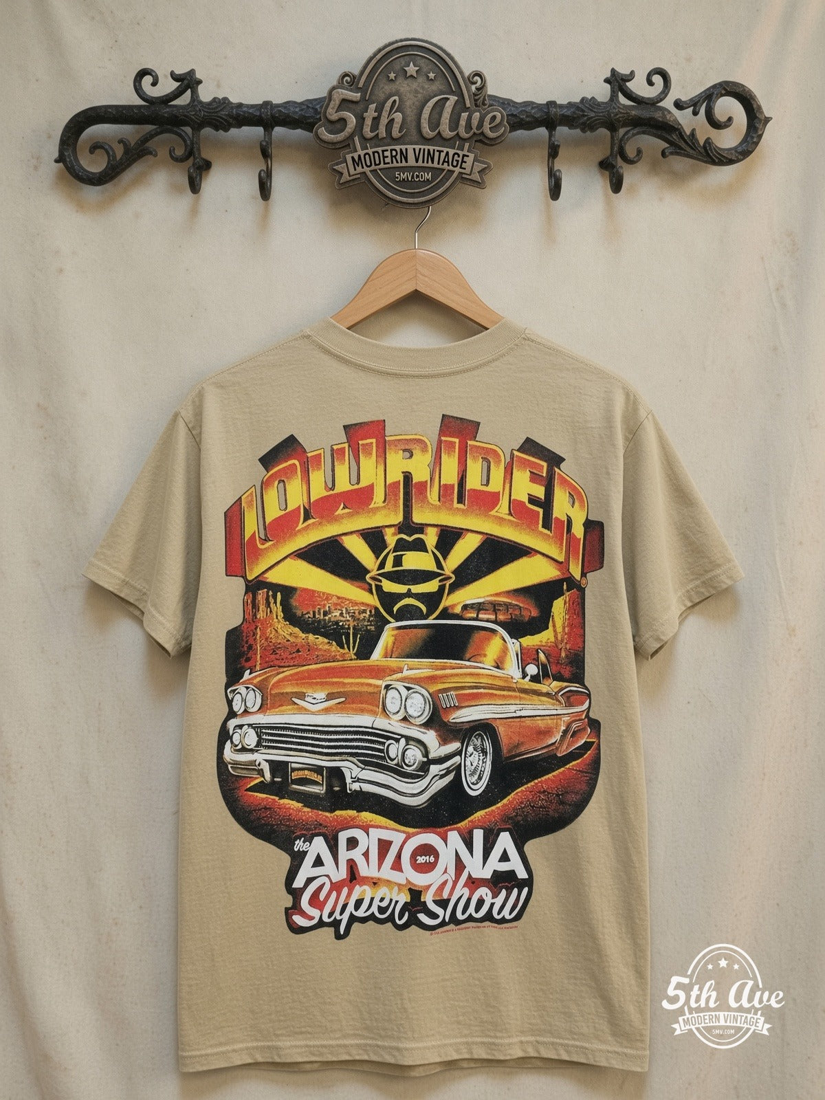 Rollin Hard Arizona Super Show Lowrider graphic tee, front view on a display rack