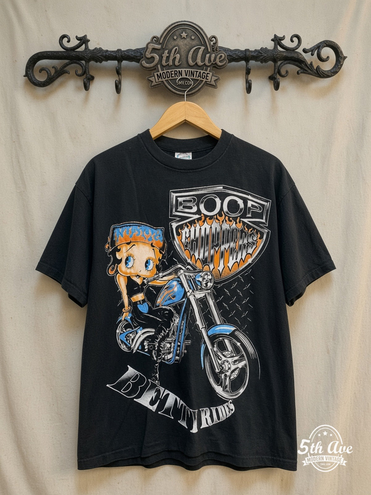 Betty Boop – Betty Rides – New Vintage Graphic Tee — front on locked cream ornate 5th Ave rack
