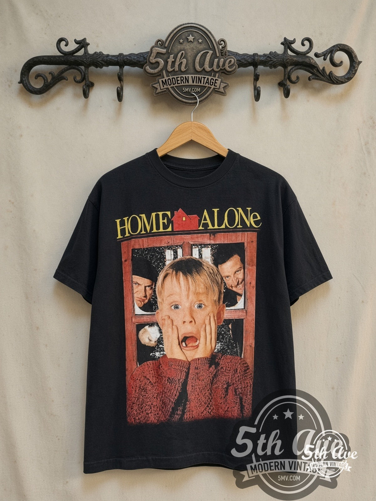 Home Alone movie tee in black, front view on a display rack