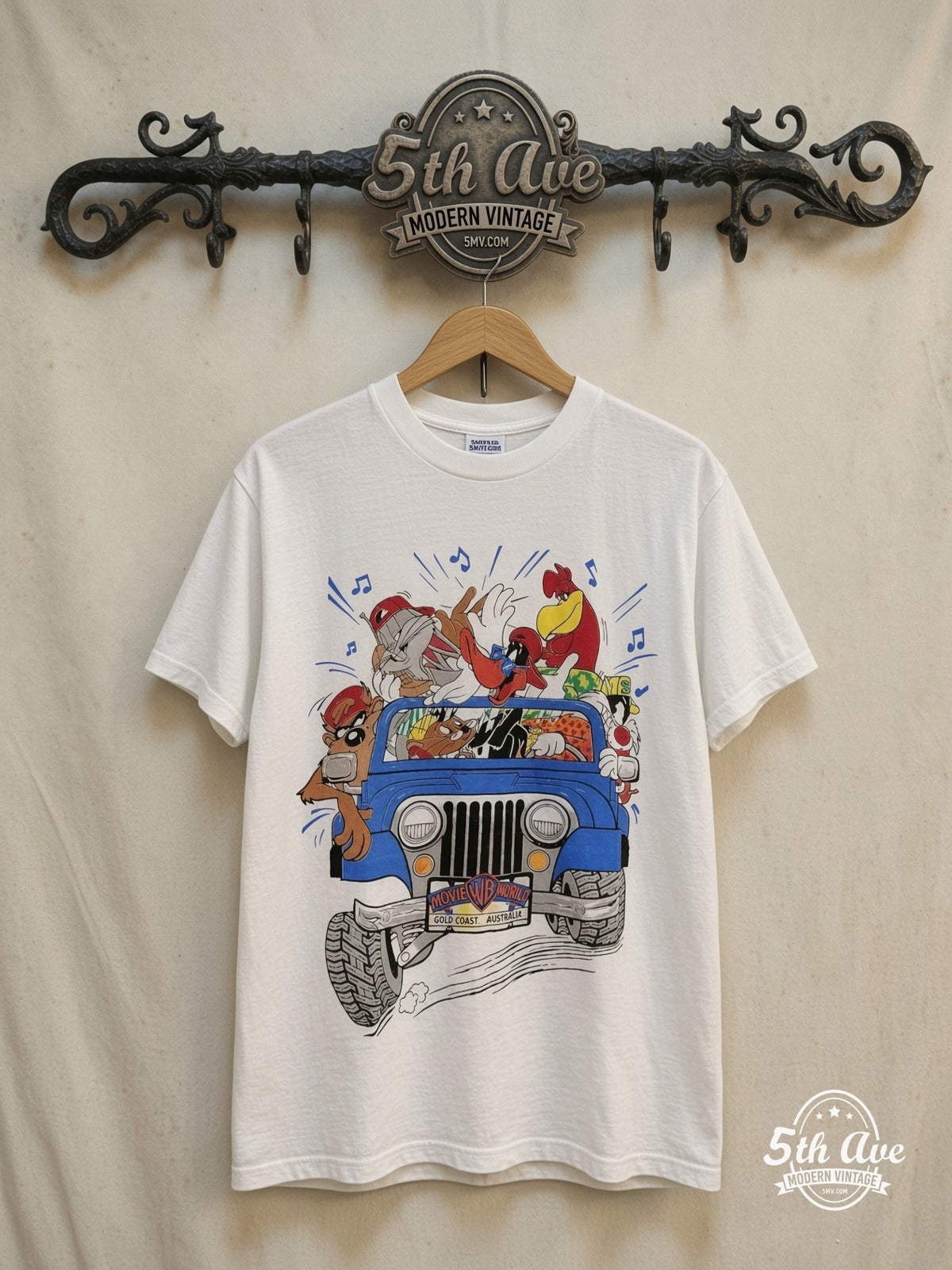 Looney Tunes Warner Brothers Gold Coast graphic tee, front view on a display rack