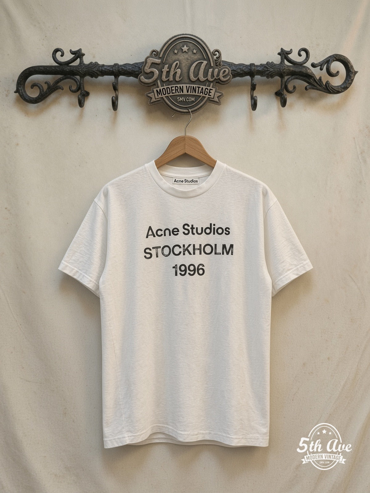 Acne Studios Stockholm 1996 graphic tee, front view on a display rack
