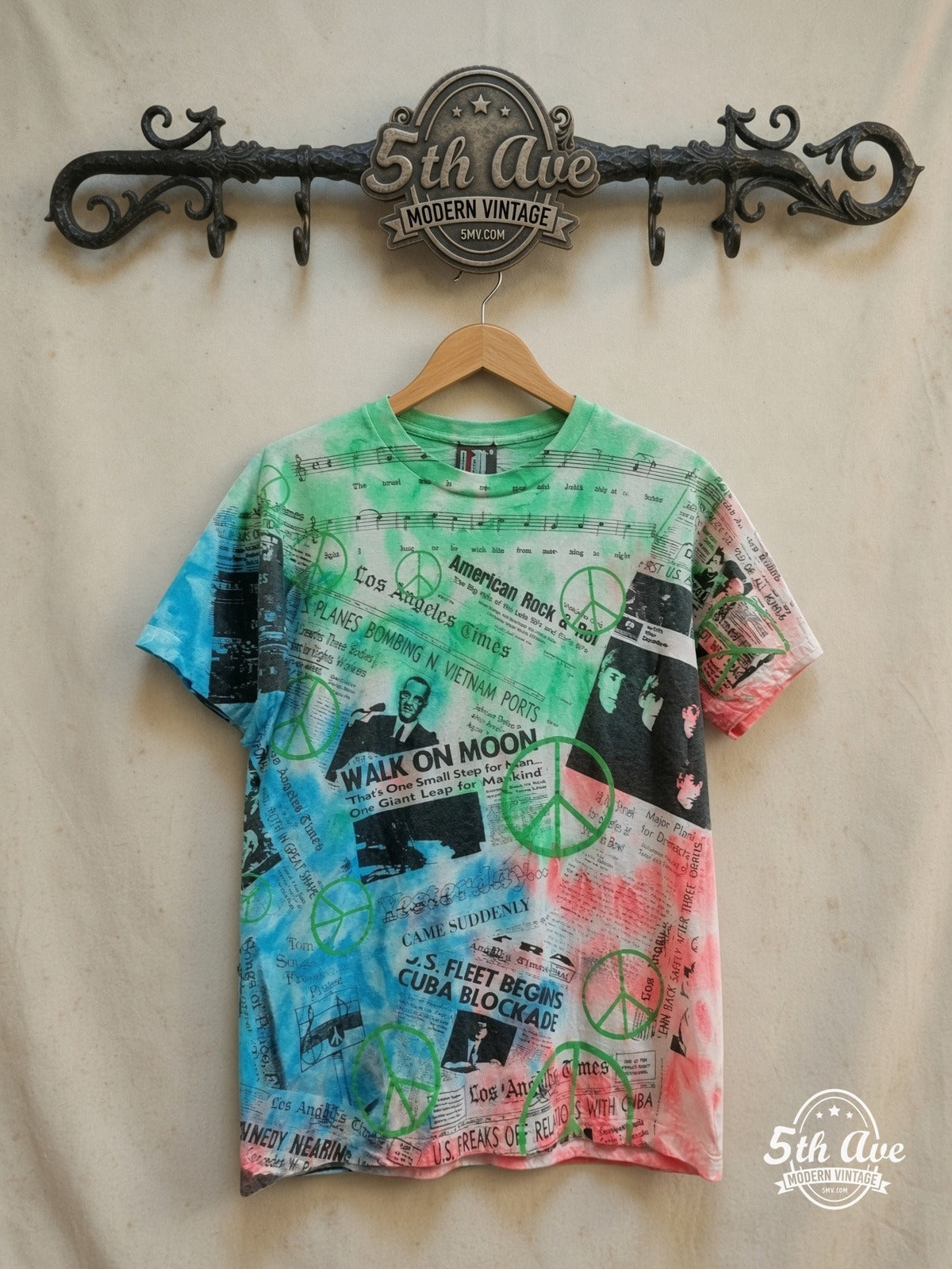 60s Pop Culture – Tie Dye Collage – Vintage Graphic Tee — front on locked cream ornate 5th Ave rack