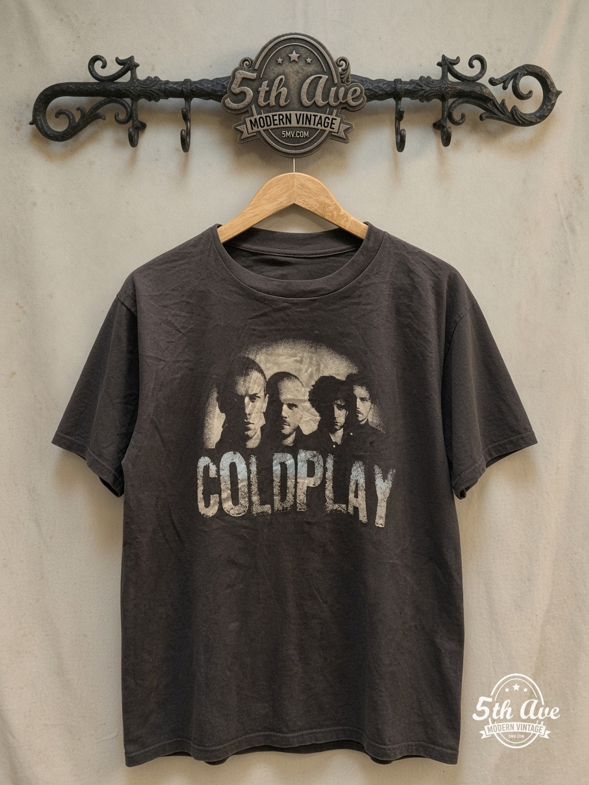 Cold play monochromatic band epic T-Shirt with a touch of light blue – Vintage Band T-Shirt — front on locked cream ornate 5th Ave rack