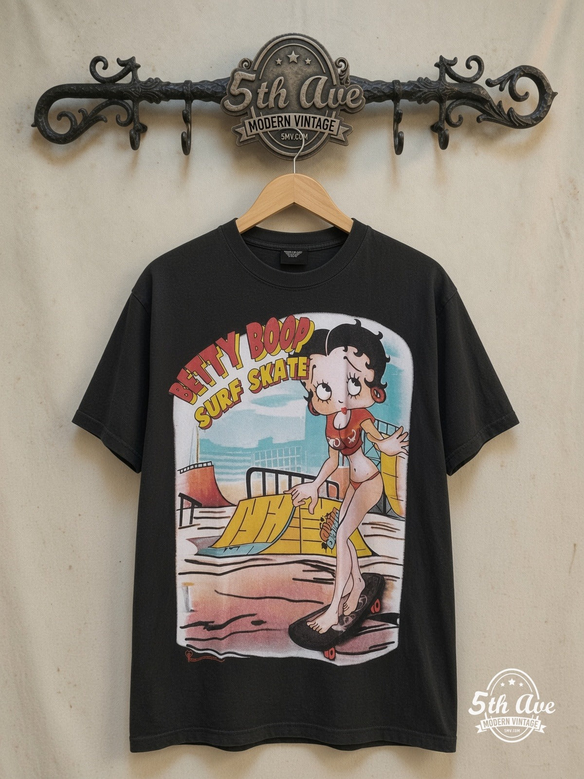 Betty Boop – I'm Good at Surf Skate - AOP all over print New Vintage Animation T-Sh – New Vintage Graphic Tee — front on locked cream ornate 5th Ave rack