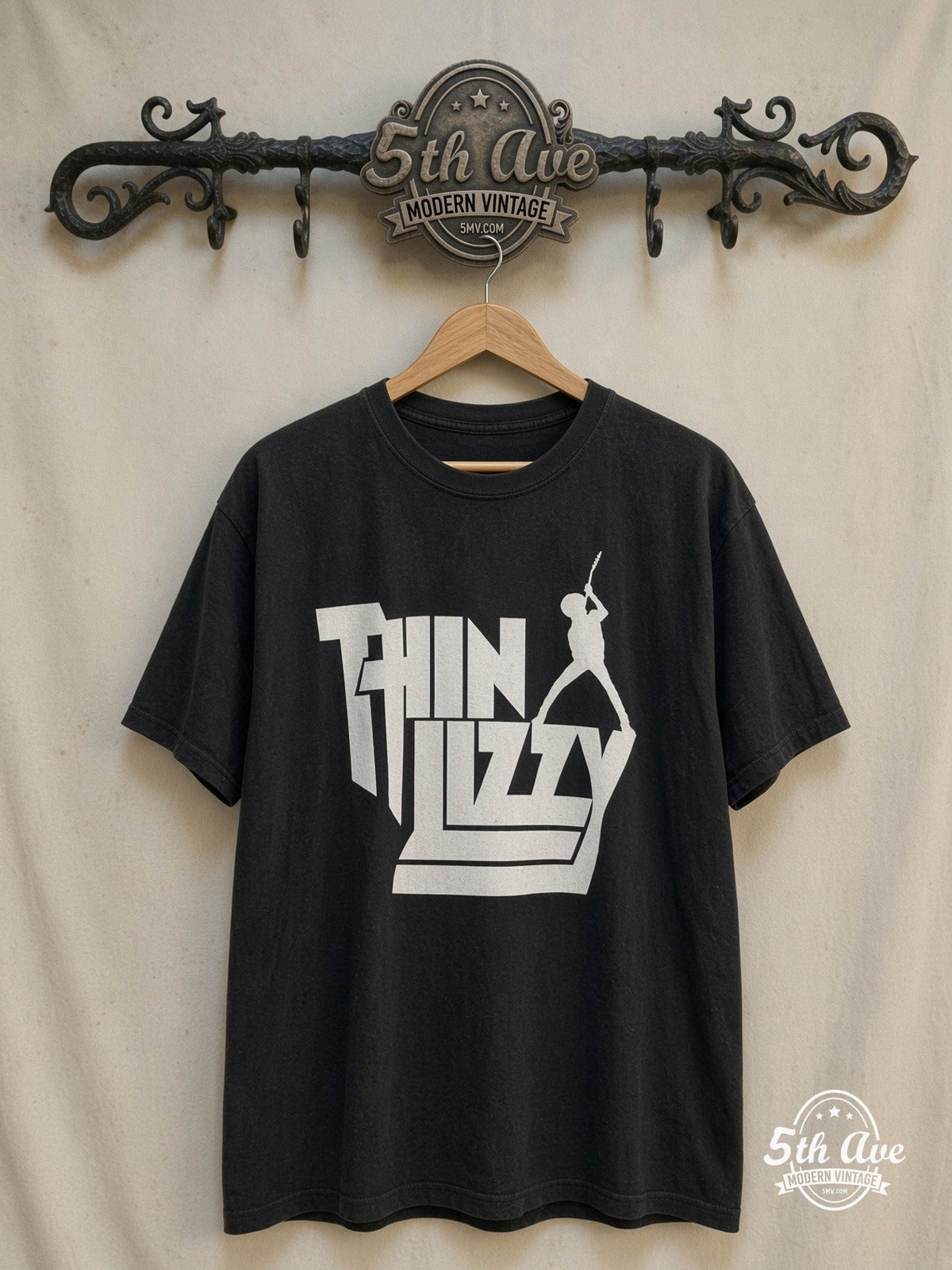 Thin Lizzy – Stacked White Logo Guitarist Silhouette – Vintage Band T-Shirt — front on locked cream ornate 5th Ave rack