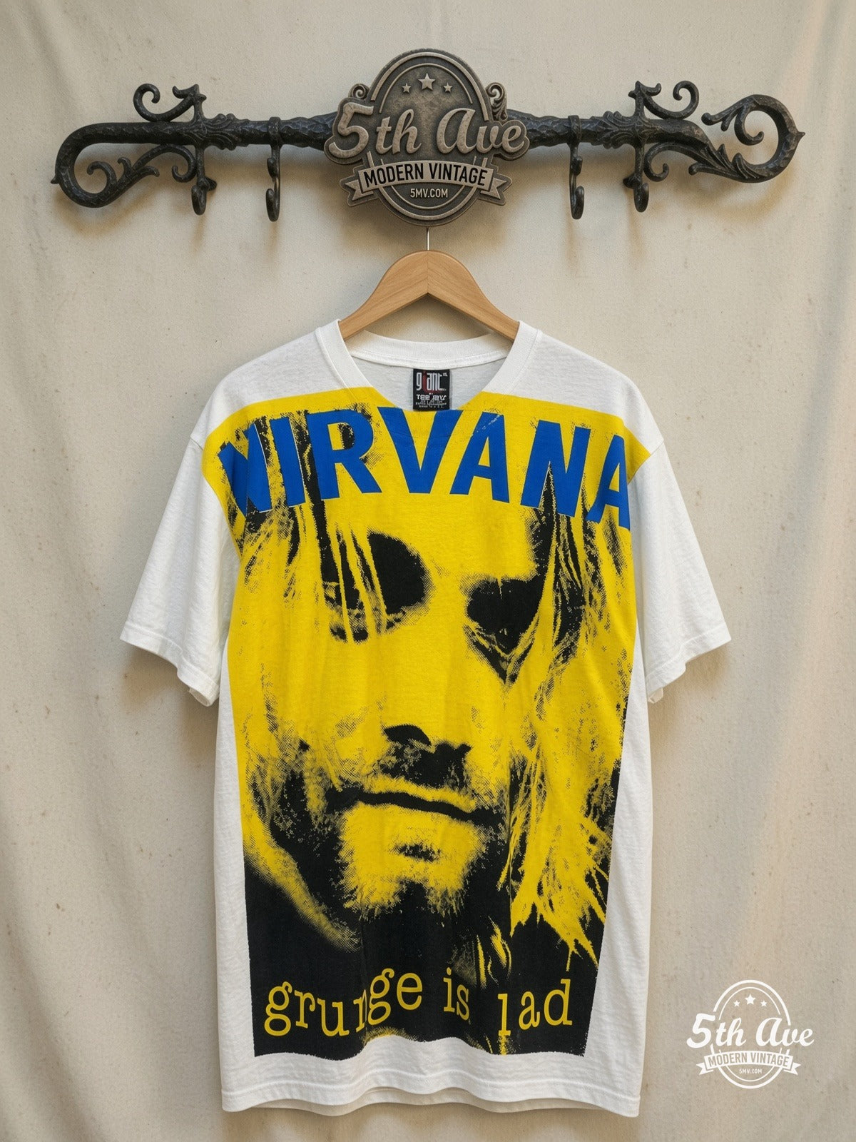 Kurt Cobain / Nirvana – Grunge Is Dead – All Over Print – Vintage Band T-Shirt — front on locked cream ornate 5th Ave rack