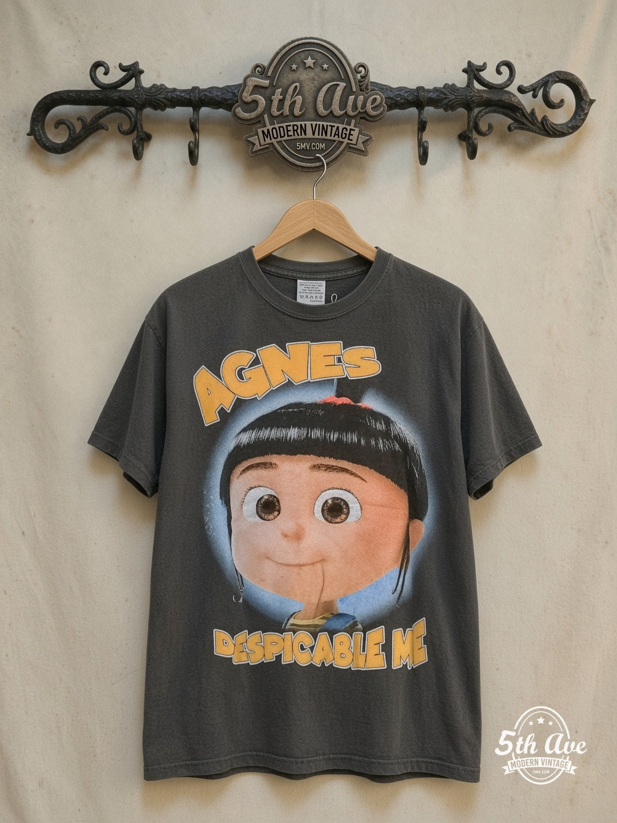 Despicable Me Agnes and Her Unicorn Adventure t shirt — front on locked cream ornate 5th Ave rack