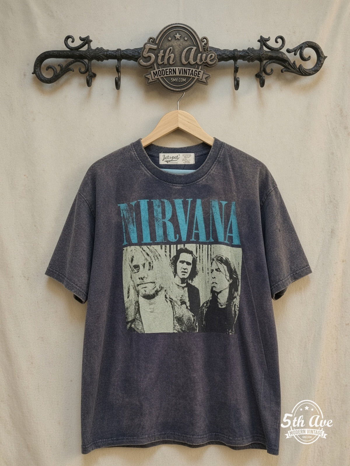 Nirvana – Aqua Logo High-Contrast Trio – Vintage Band T-Shirt — front on locked cream ornate 5th Ave rack