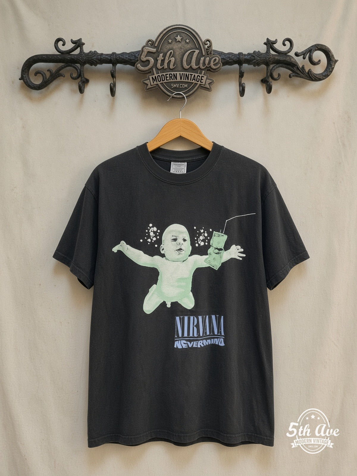 Nirvana – Nevermind Baby – Vintage Band T-Shirt — front on locked cream ornate 5th Ave rack
