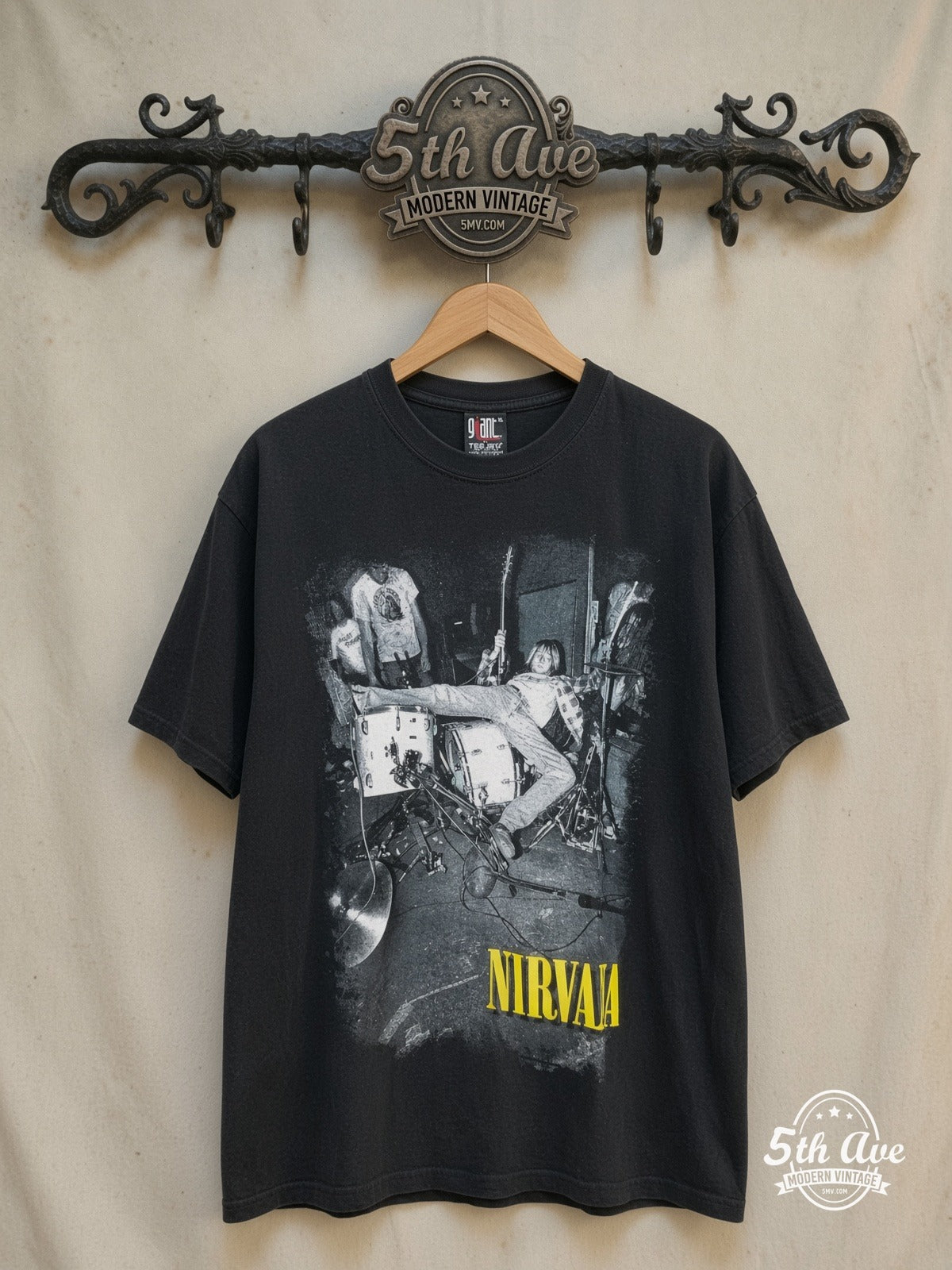 Nirvana – Kurt Cobain Drum Jump Live – Vintage Band T-Shirt — front on locked cream ornate 5th Ave rack