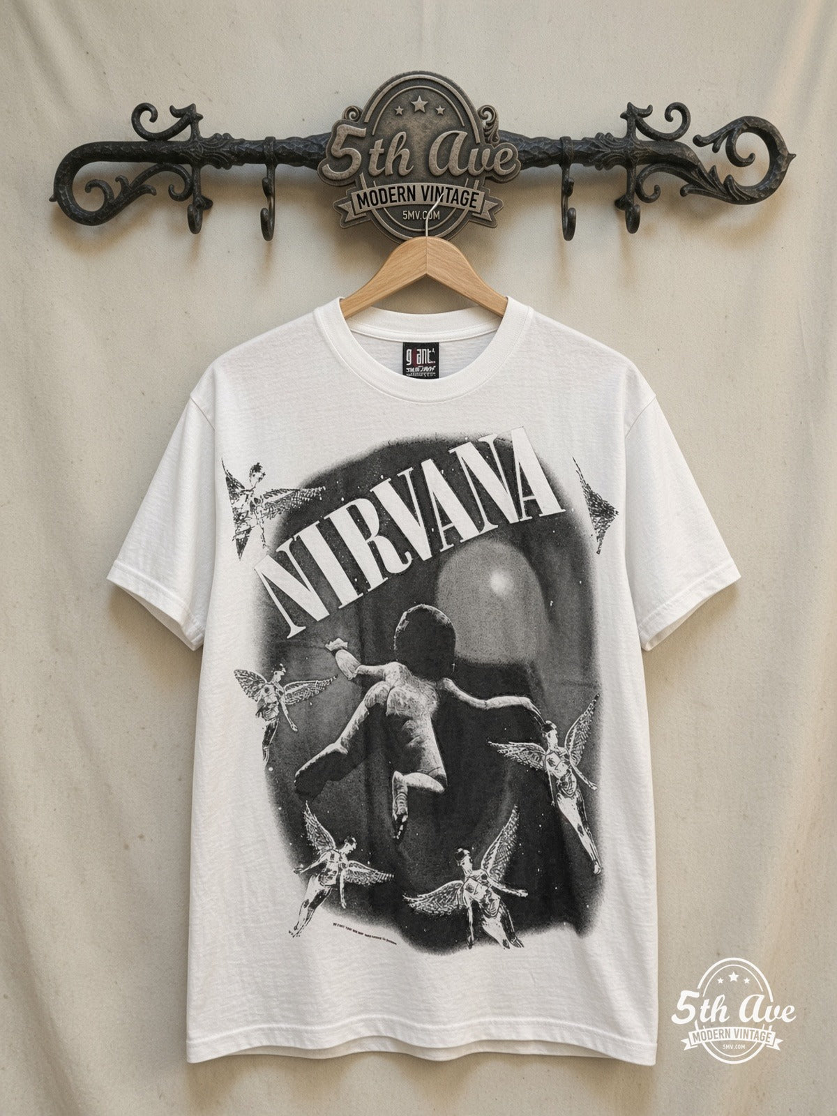 Nirvana – Nevermind Baby & Angels Oval – Vintage Band T-Shirt — front on locked cream ornate 5th Ave rack