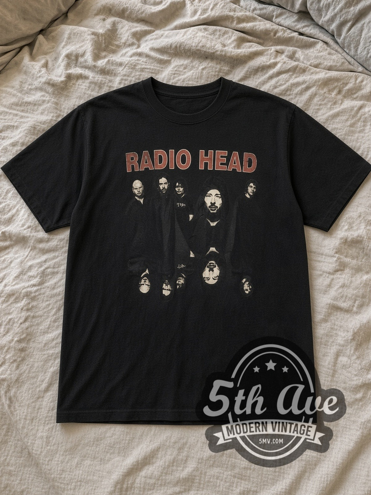 Black Radiohead RADIO HEAD Mirrored Upside Down Head Vintage Band T-Shirt laid flat on a linen bed
