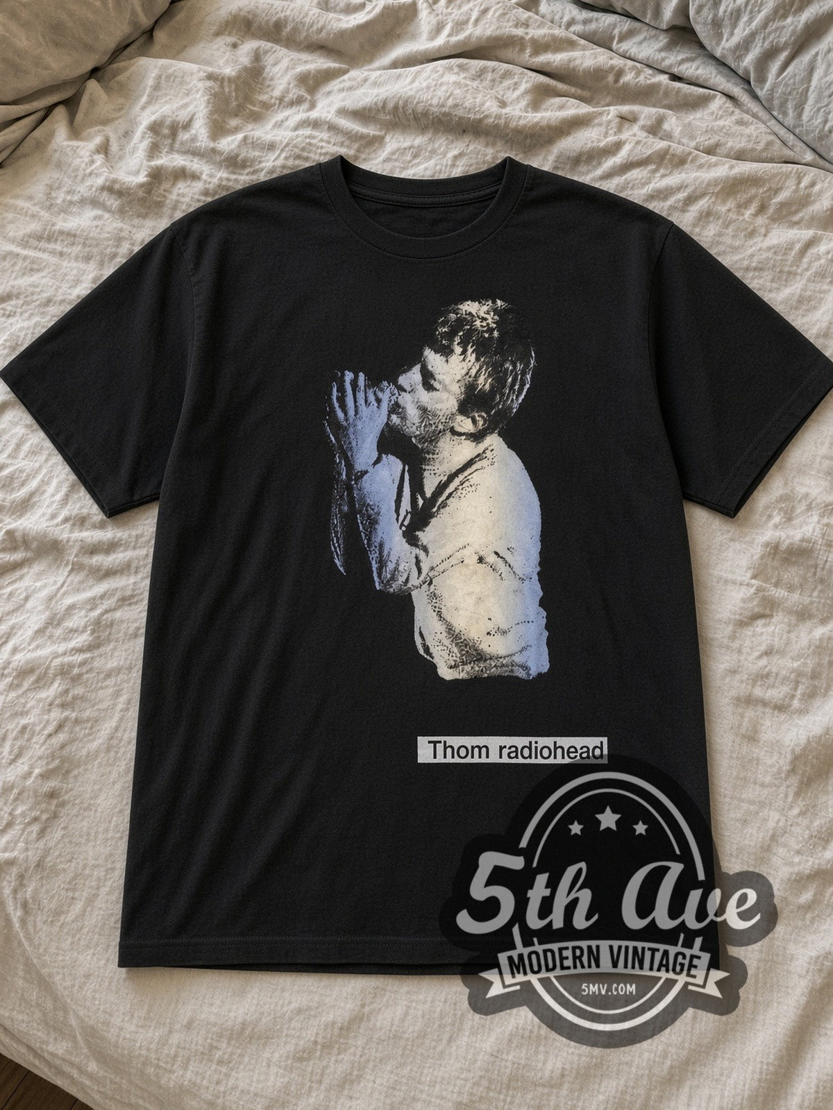 Black Radiohead THOM YORKE Vintage Band T-Shirt laid flat on a linen bed