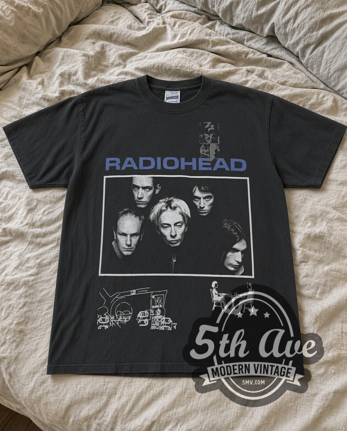 Faded black Radiohead band photo Bends tee laid flat on linen bed