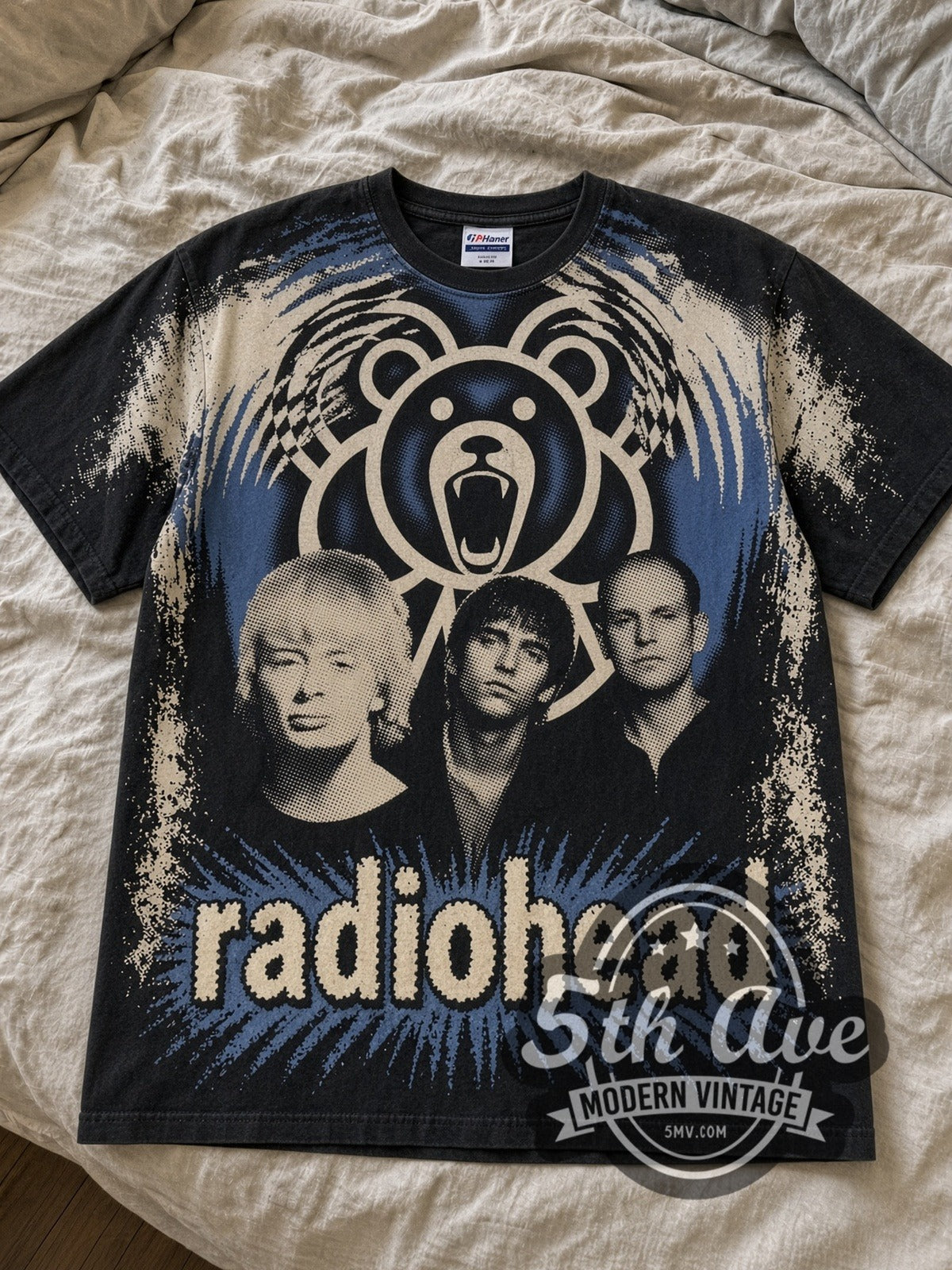 Black Radiohead bleach all over print tee laid flat on linen bed