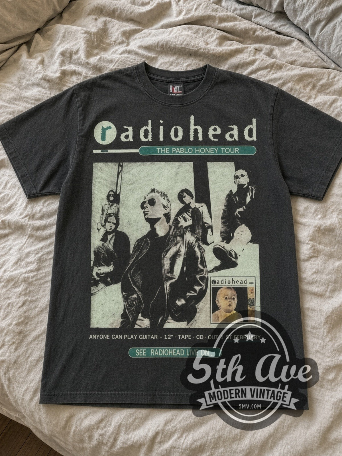 Radiohead Pablo Honey Bear Logo band t-shirt in black laid flat on a bed, front artwork