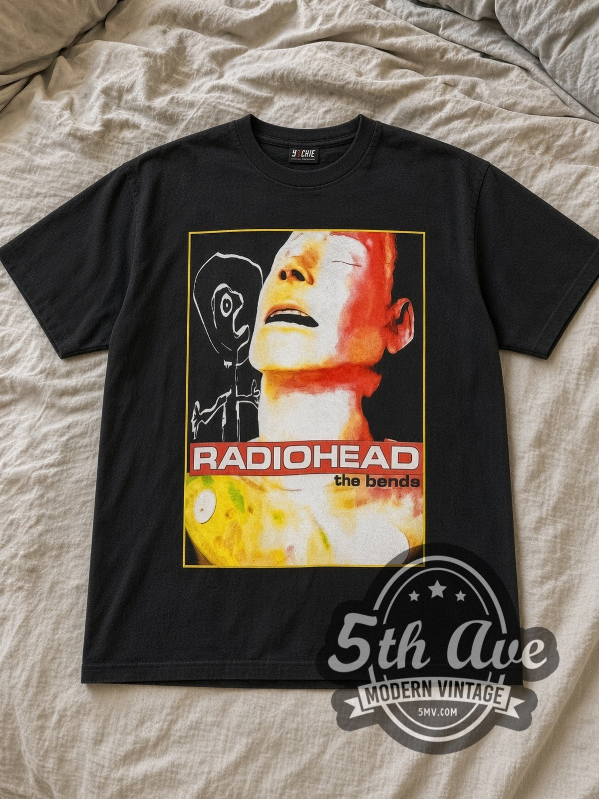 Black Radiohead The Bends Mannequin Face Tracklist Vintage Band T-Shirt laid flat on a linen bed