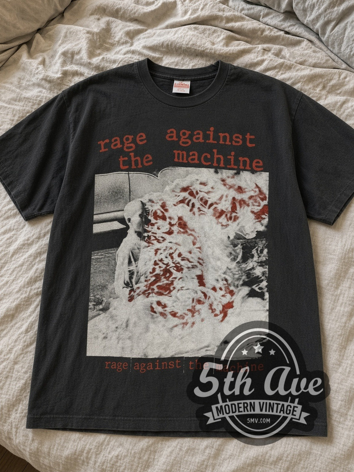 Faded black Rage Against the Machine Burning Monk May-June 1993 Tour tee laid flat on linen bed