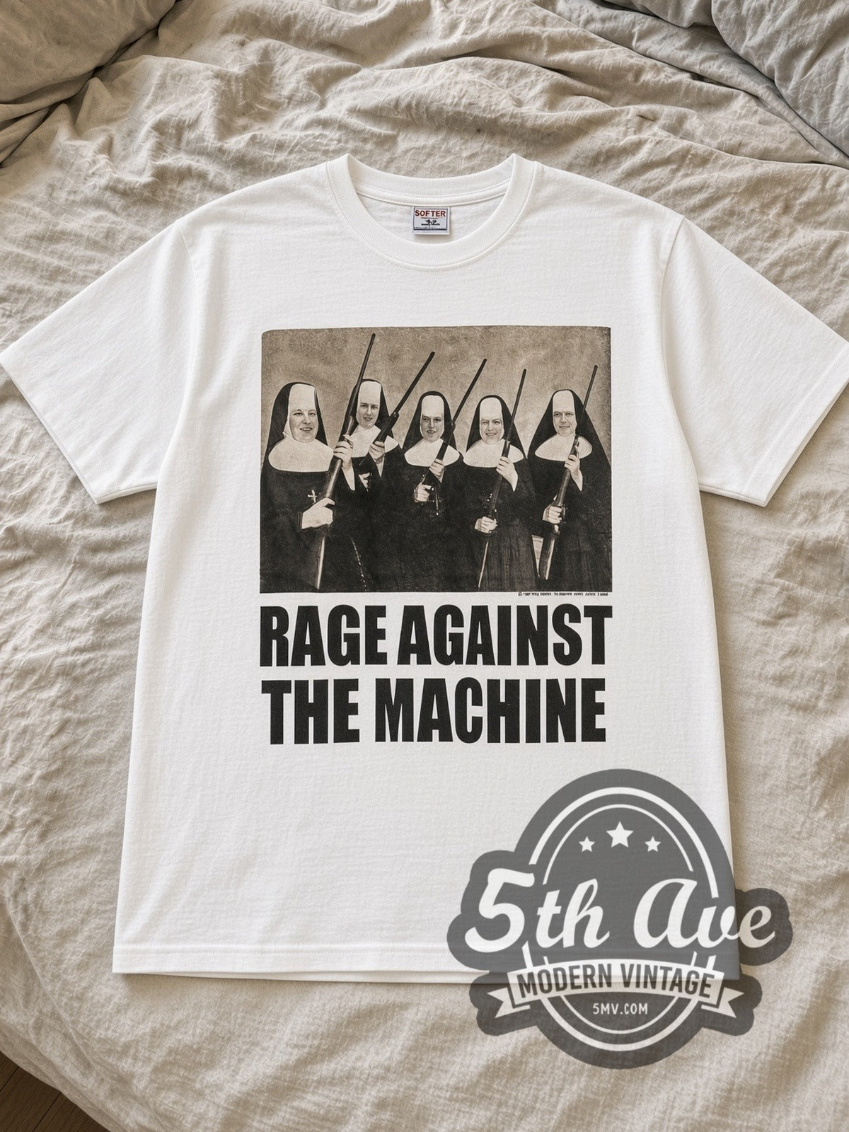 White Rage Against the Machine Nuns And Guns Vintage Band T-Shirt laid flat on a linen bed