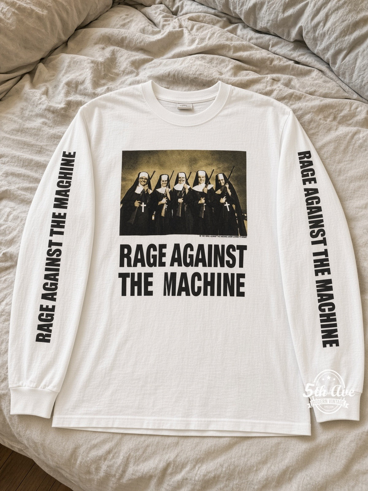 Rage Against the Machine Nuns With Guns White Long Sleeve vintage tee laid on bed