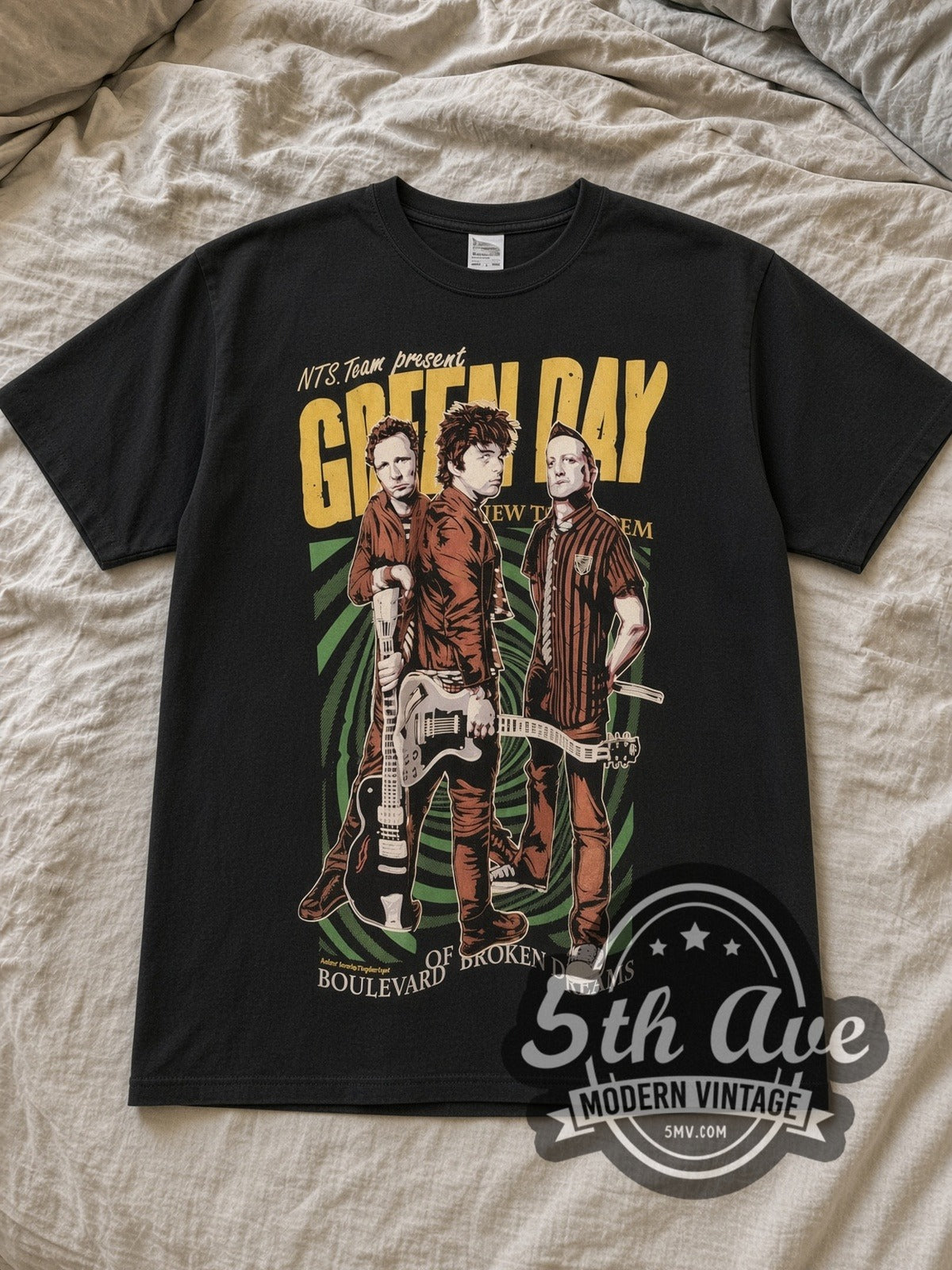 Black Green Day Revolution Radio Vintage Band T-Shirt laid flat on a linen bed