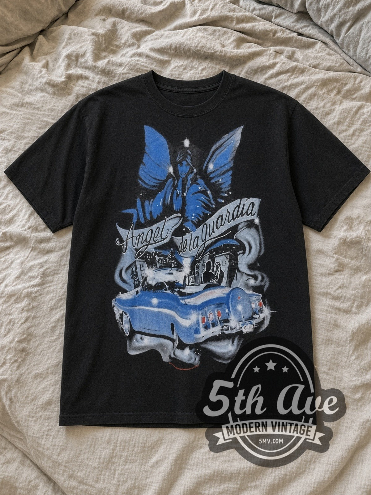 Black Rollin Hard Angel de la Guardia Lowrider Vintage Graphic T-Shirt laid flat on a linen bed