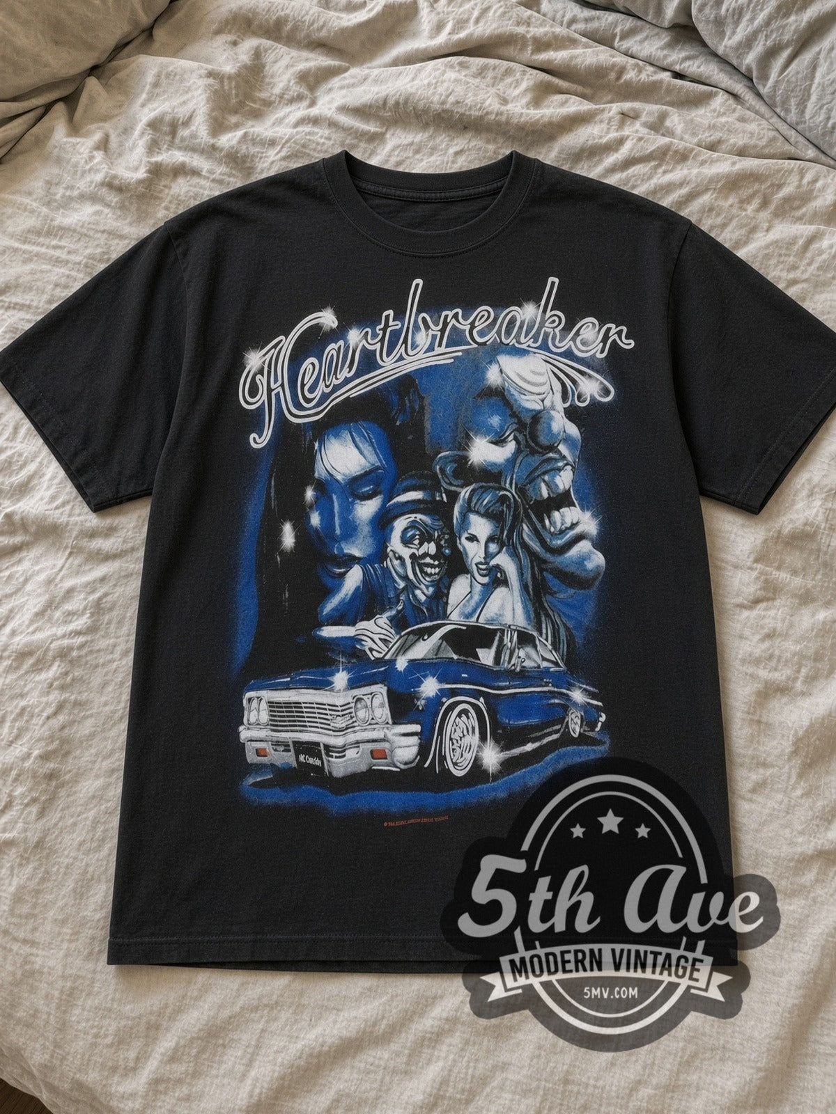 Black Rollin Hard Heartbreaker Lowrider Vintage Graphic T-Shirt laid flat on a linen bed