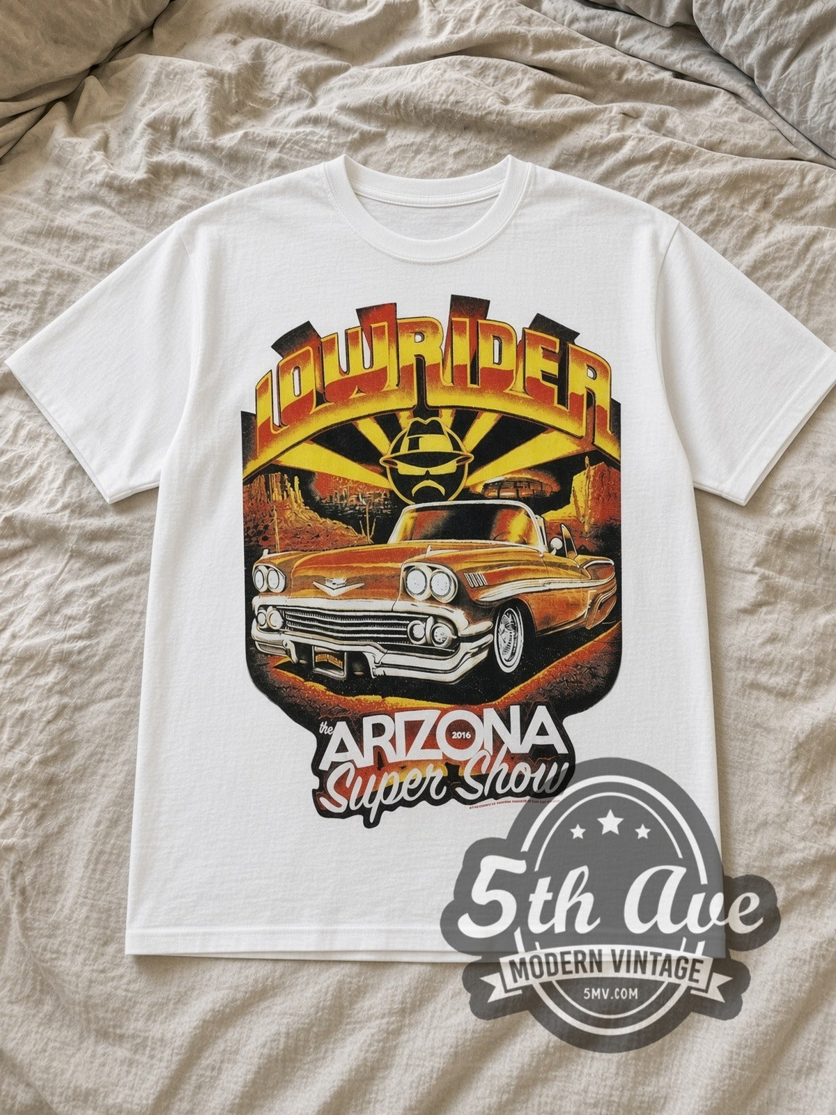 White Rollin Hard The Arizona Super Show 2016 Vintage Graphic T-Shirt laid flat on a linen bed
