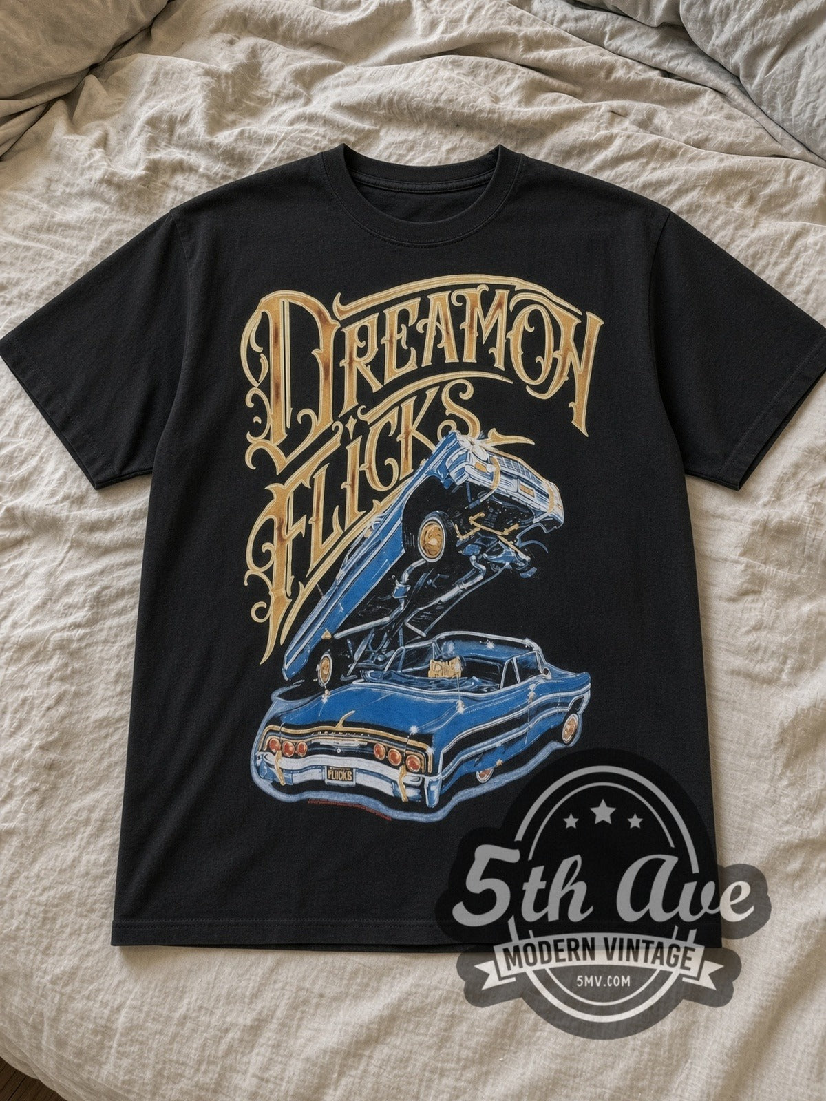 Black Rollin Hard Lowrider Dreams and Hydraulic Scenes Vintage Graphic T-Shirt laid flat on a linen bed
