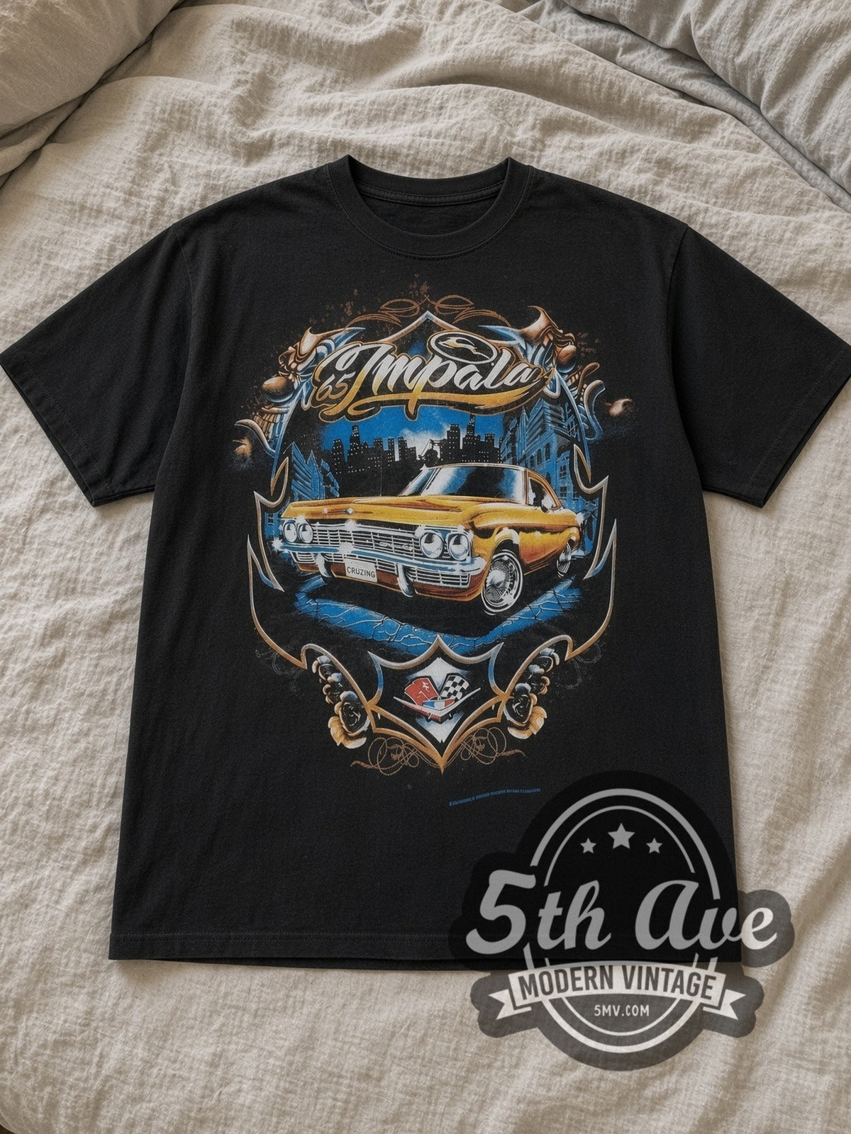 Black Rollin Hard '65 Chevy Impala Lowrider Vintage Graphic T-Shirt laid flat on a linen bed