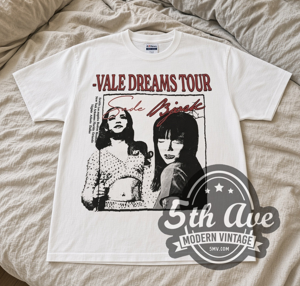 White Sade and Bjork Vale Dreams Tour tee laid flat on linen bed