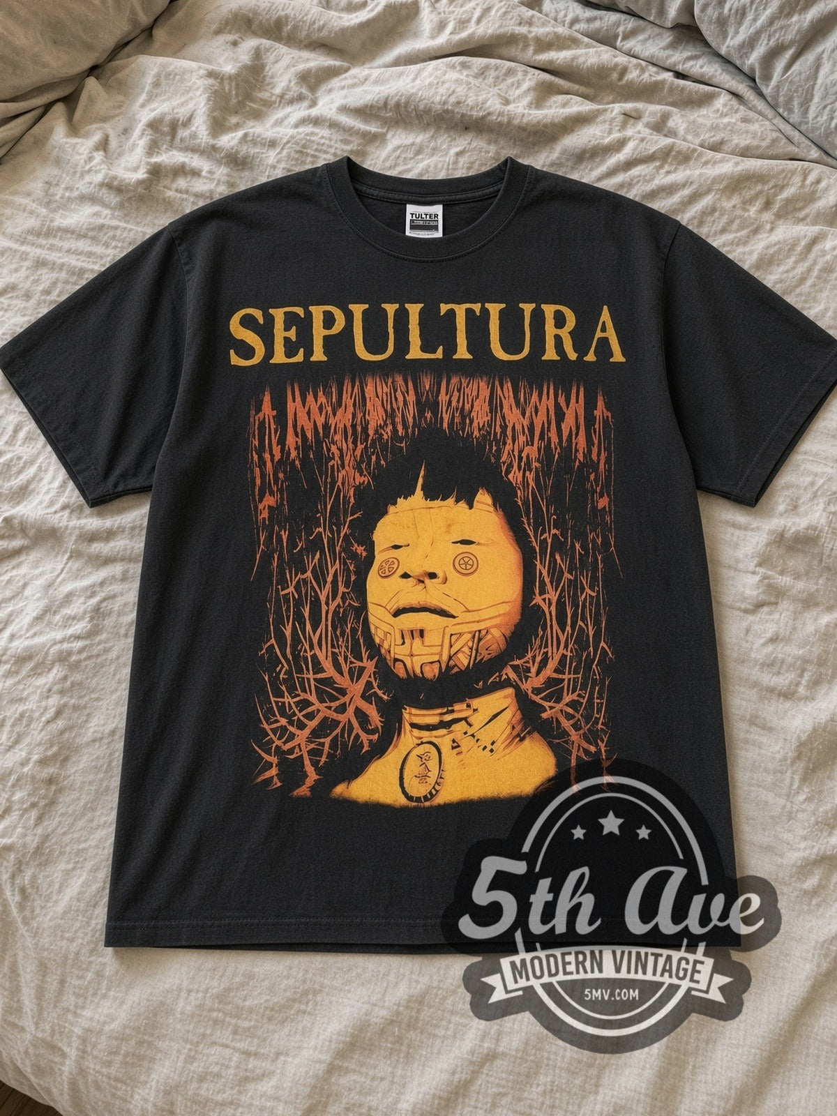 Black Sepultura Roots Vintage Band T-Shirt laid flat on a linen bed