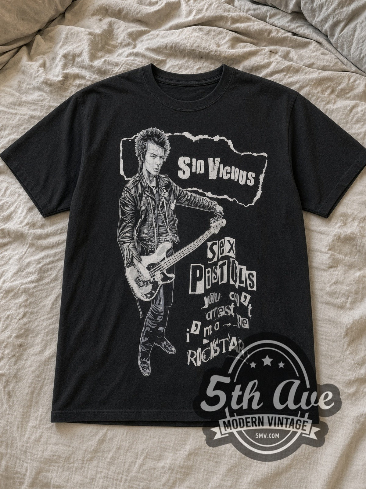 Black Sex Pistols Sid Vicious Rockstar Vintage Band T-Shirt laid flat on a linen bed