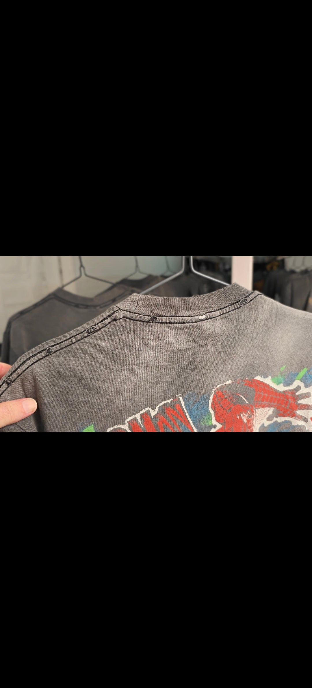 Distressed collar and shoulder holes on faded graphic tee — shirt distressing detail