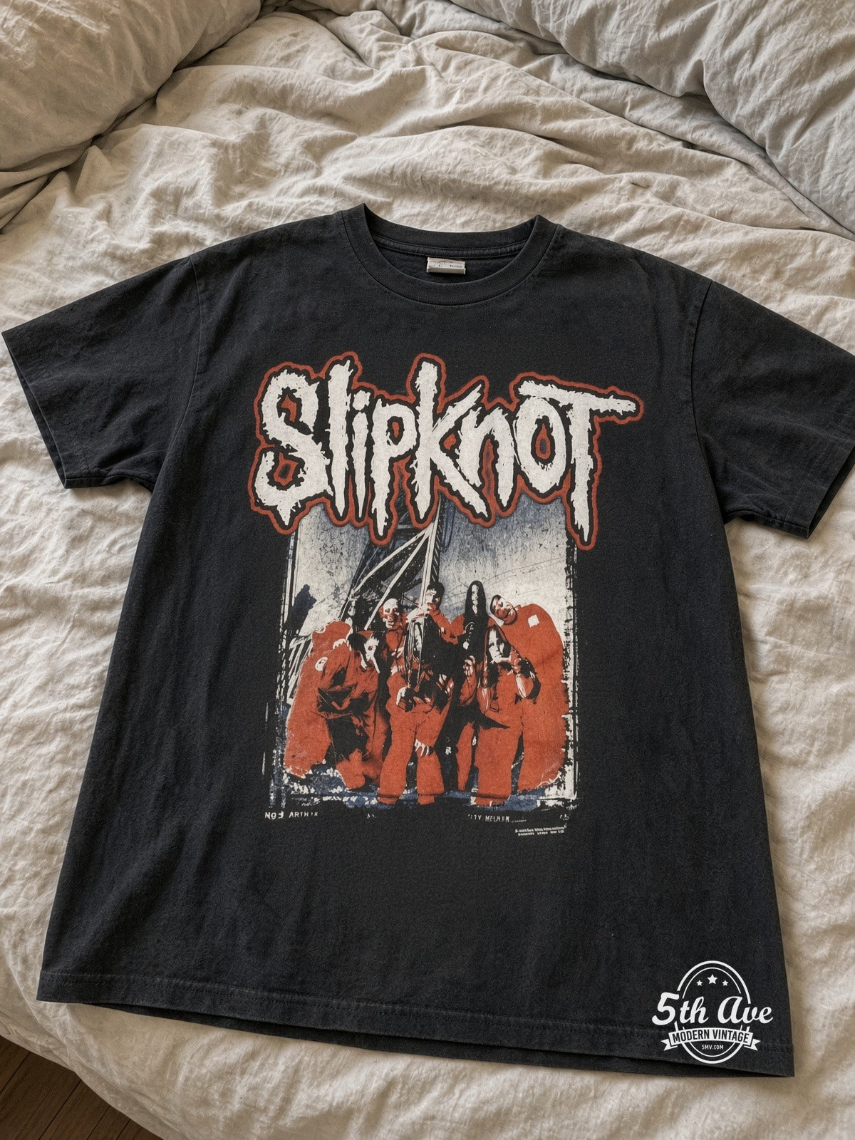 Slipknot Red Jumpsuits Group Barcode vintage tee laid on bed