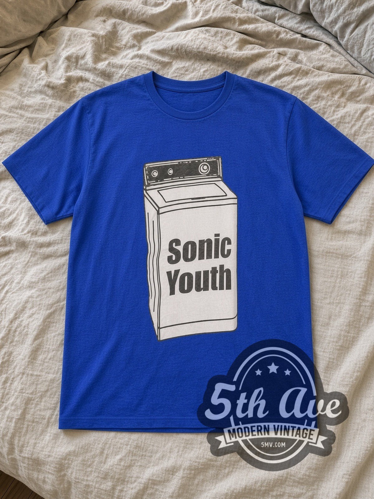 Blue Sonic Youth Washing Machine Vintage Band T-Shirt laid flat on a linen bed