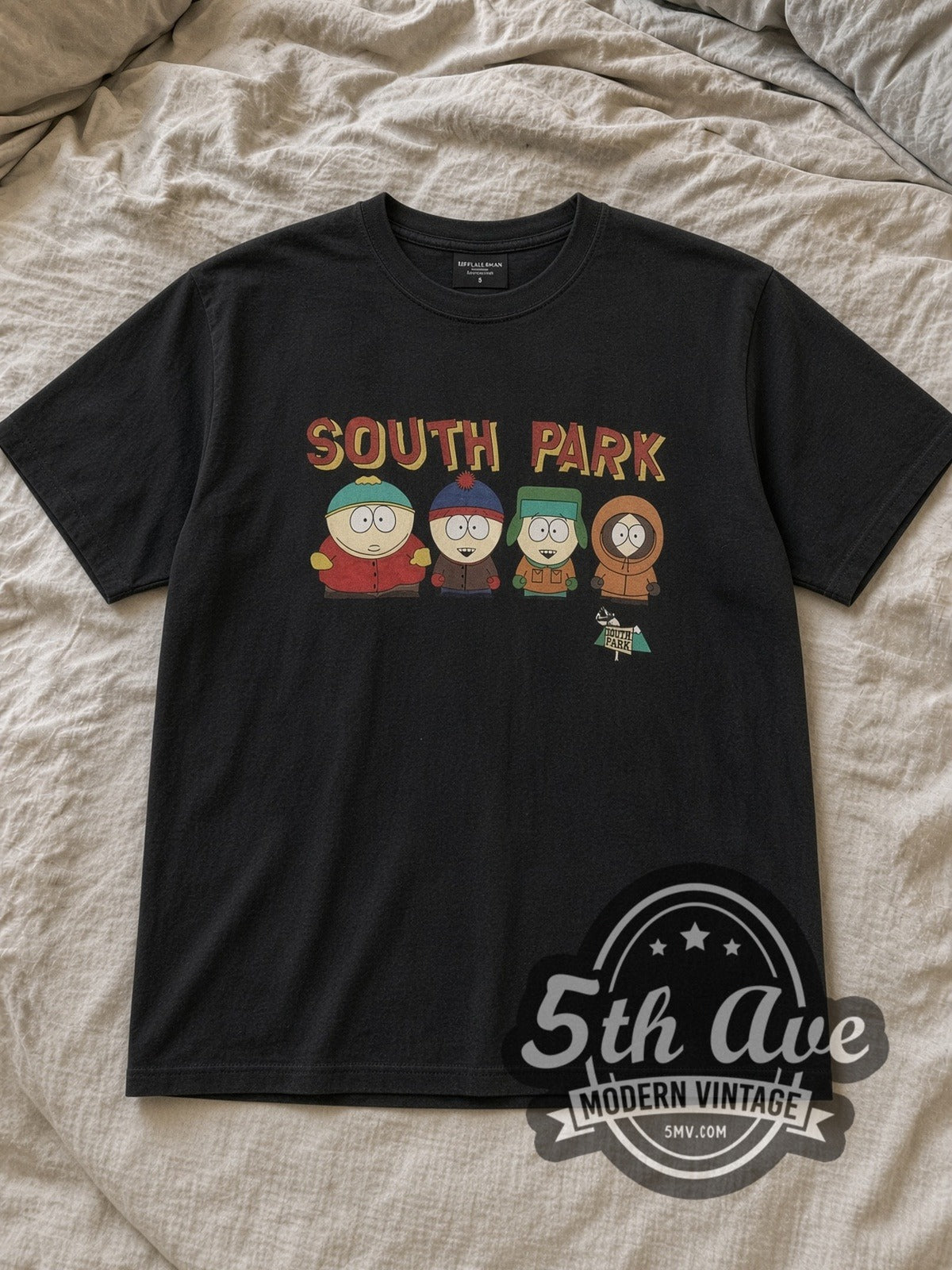 Black South Park Vintage Cartoon T-Shirt laid flat on a linen bed