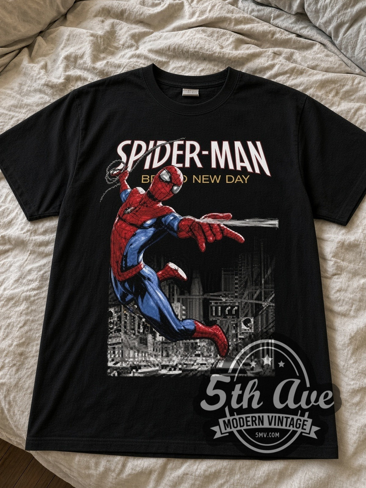 Spider-Man Brand New Day Web-Swinging black graphic tee laid flat on linen bed
