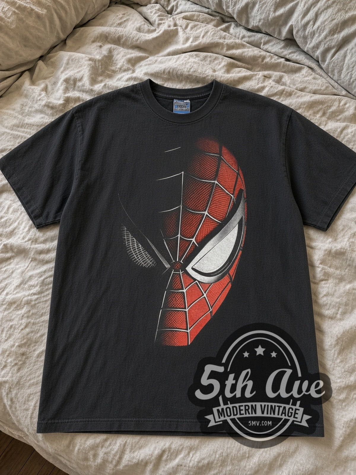 Black Spider-Man half mask tee laid flat on linen bed