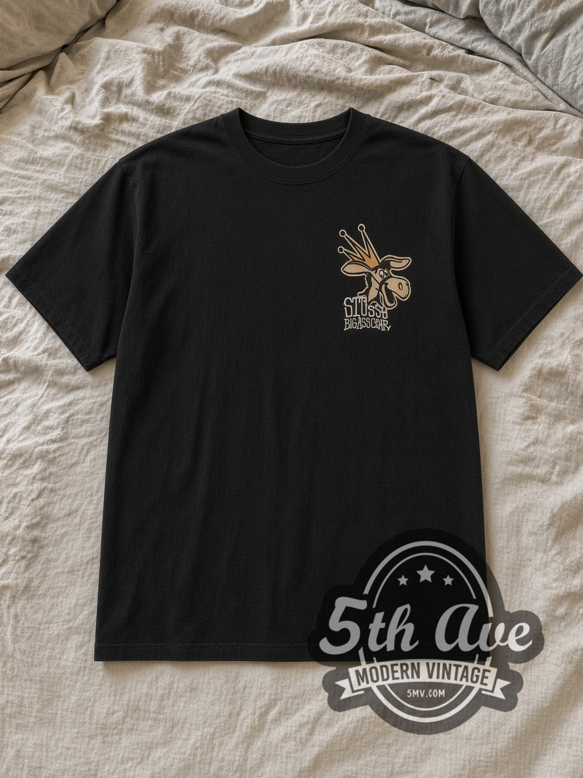 Black Stussy Big Ass Gear Vintage Graphic T-Shirt laid flat on a linen bed