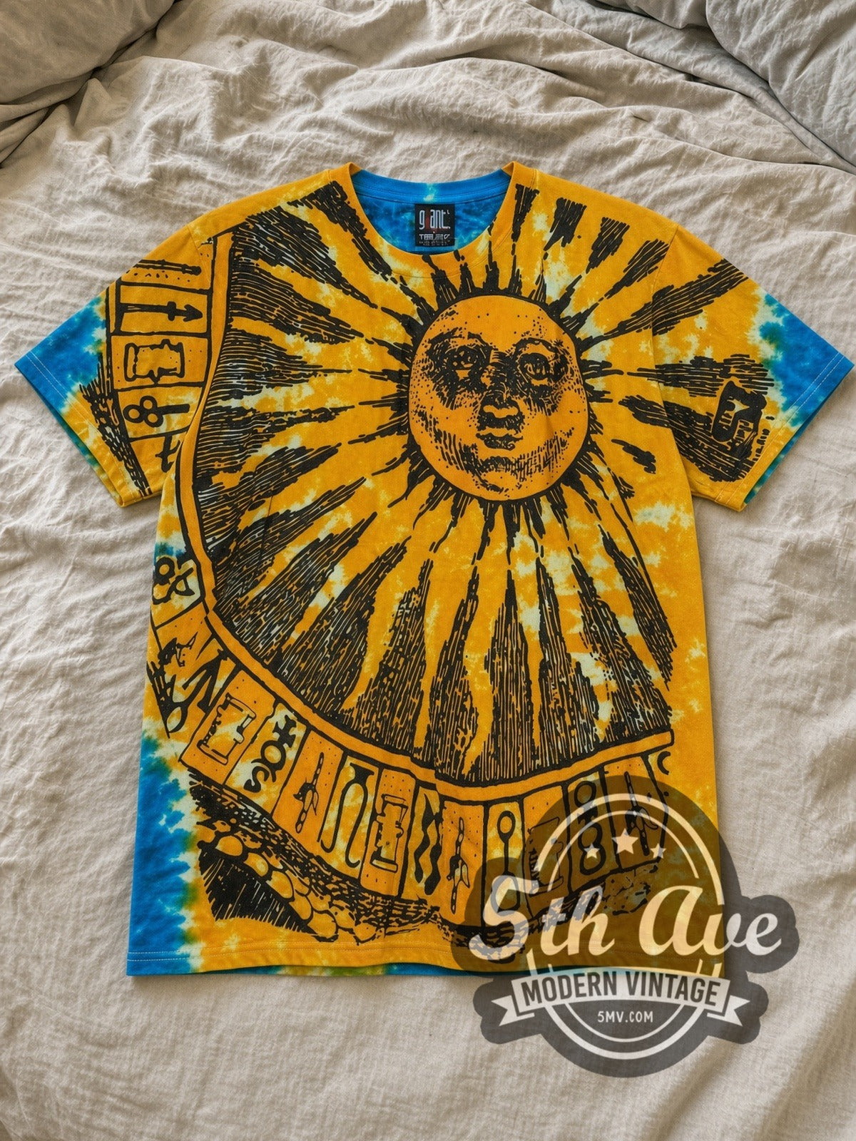 Tie-Dye Sun and Moon Tie Dye Sun and Moon All Over Print Vintage Graphic T-Shirt laid flat on a linen bed