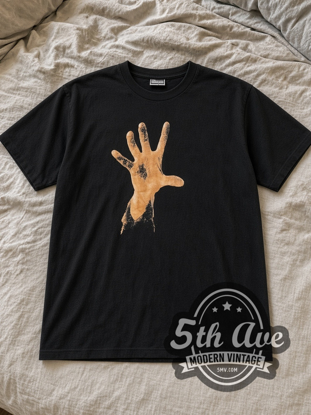 Black System of a Down Debut Studio Album 1998 Vintage Band T-Shirt laid flat on a linen bed