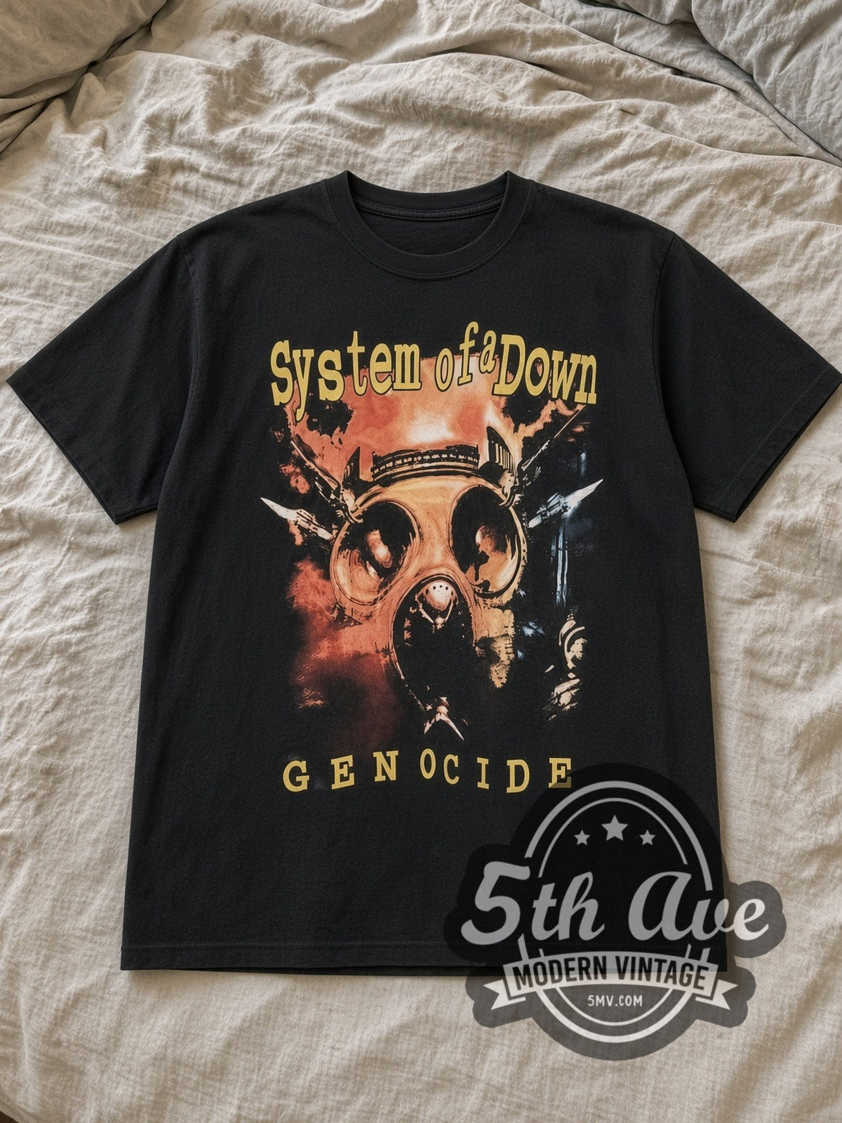 Black System of a Down Genocide Vintage Band T-Shirt laid flat on a linen bed