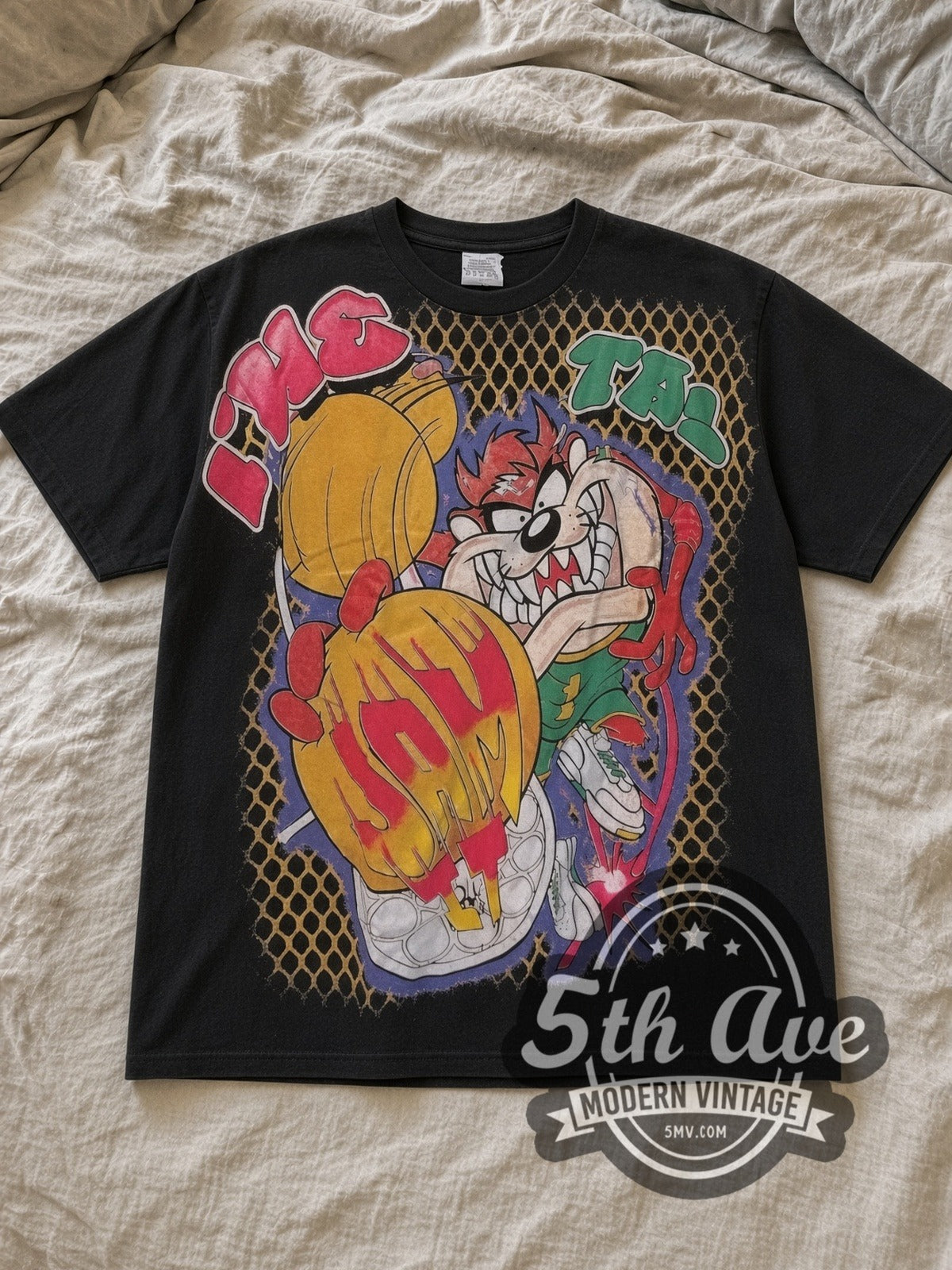 Black Taz Jam It Vintage Cartoon T-Shirt laid flat on a linen bed