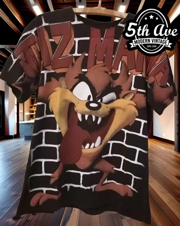 Taz-Mania All-Over Print Looney Tunes vintage t-shirt laid on bed