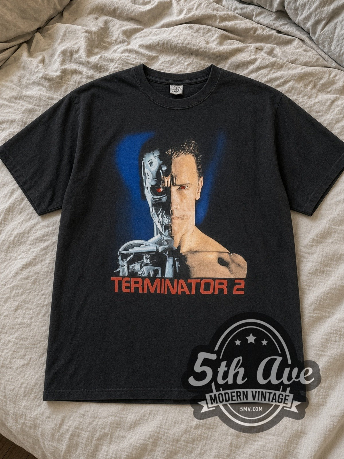 Black Terminator 2 Judgment Day Vintage Movie T-Shirt laid flat on a linen bed